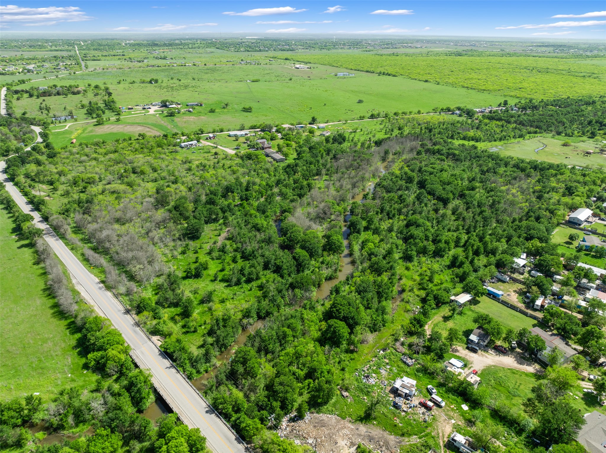 0 Jacobson Road Del Valle, TX 78617 - Photo 17 of 40 a view of a green field with lots of bushes