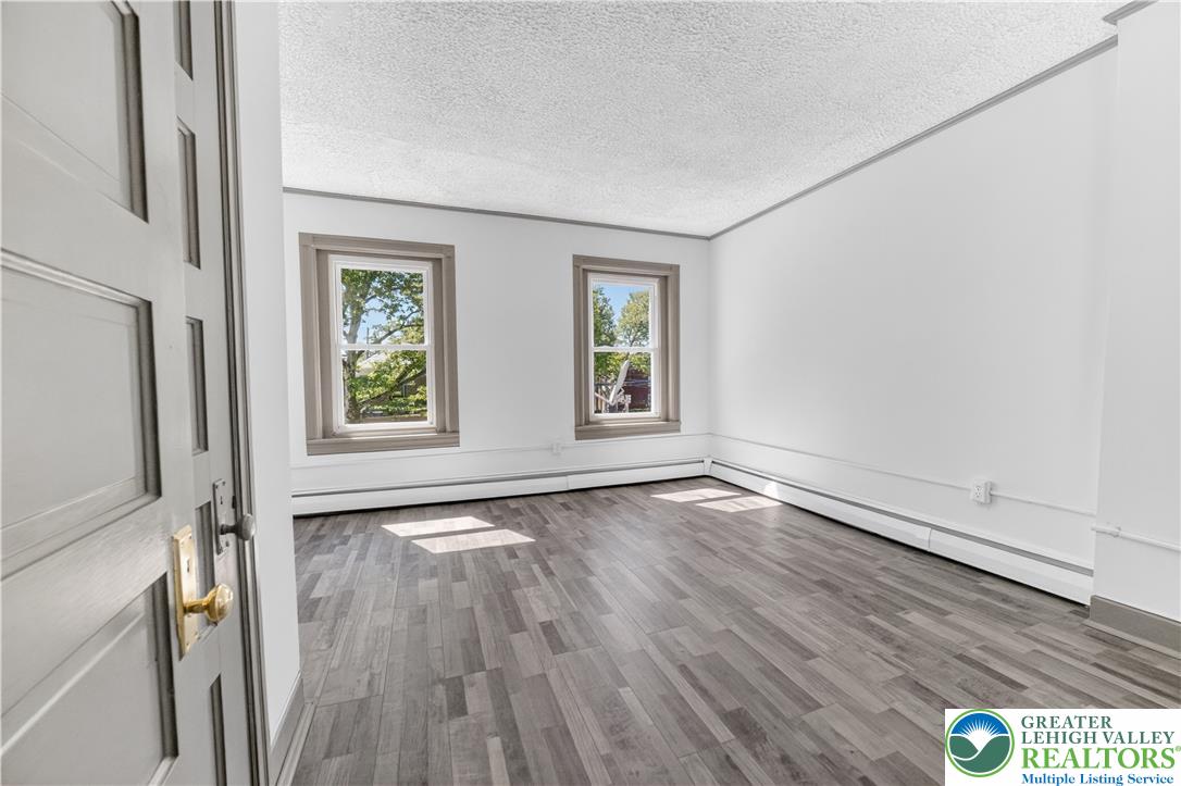 1128 Maple Street Bethlehem, PA 18018 - Photo 14 of 34 Natural light streams into this versatile room with durable laminate flooring.