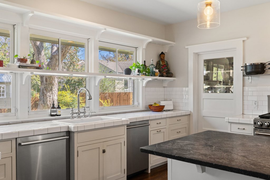 3107 Beverly Road Austin, TX 78703 - Photo 13 of 40 a kitchen with a sink a window and cabinets