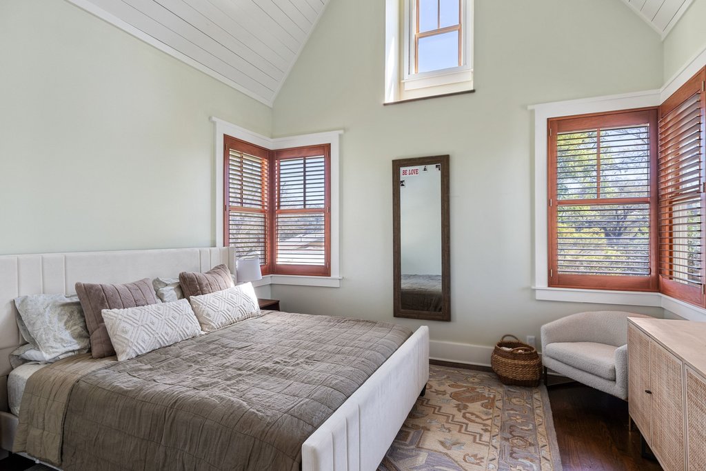 3107 Beverly Road Austin, TX 78703 - Photo 22 of 40 a bedroom with a bed and wooden floor