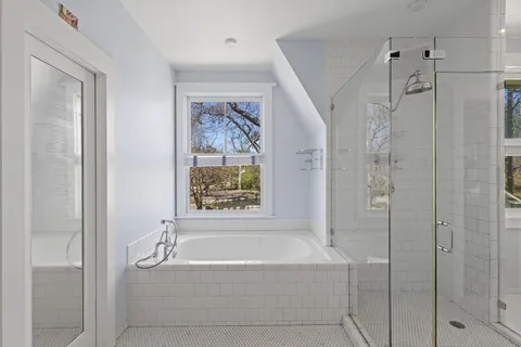 a bathroom with a bathtub and shower