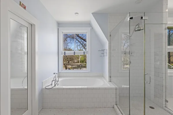a bathroom with a bathtub and shower