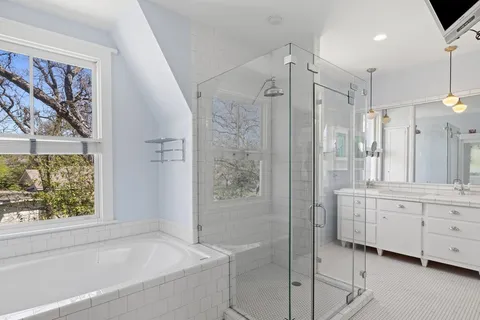 a bathroom with a bathtub and a shower
