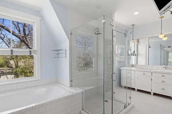 a bathroom with a bathtub and a shower