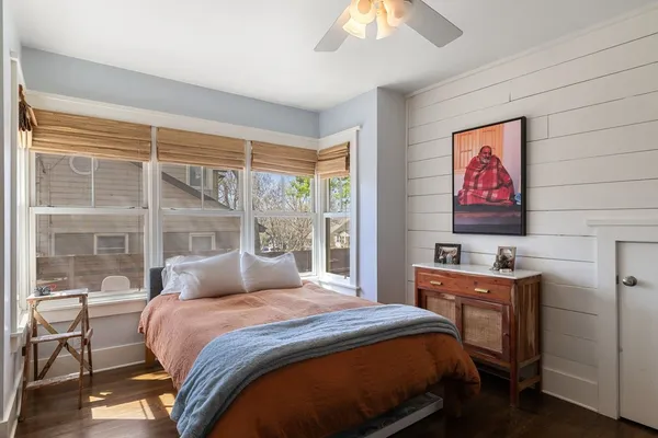 a bedroom with a bed and a window