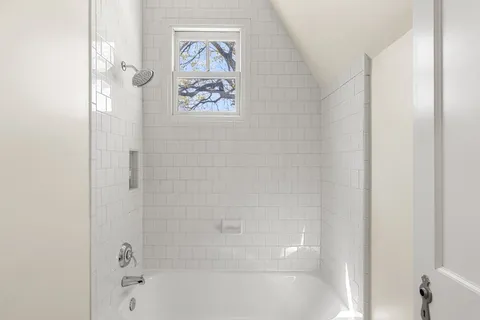 a bathroom with a bathtub and a shower