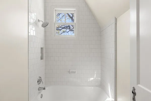 a bathroom with a bathtub and a shower