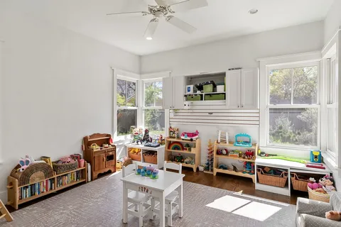 a reading room with furniture a rug and a window