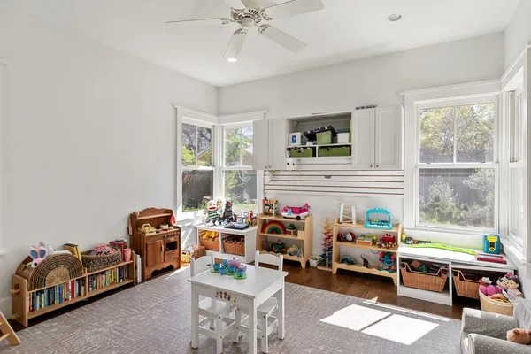 a reading room with furniture a rug and a window