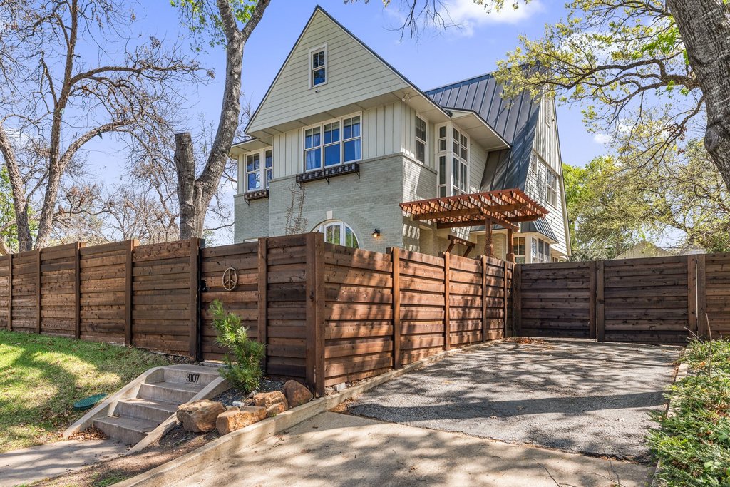 3107 Beverly Road Austin, TX 78703 - Photo 40 of 40 a view of a house with a wooden fence and a pathway