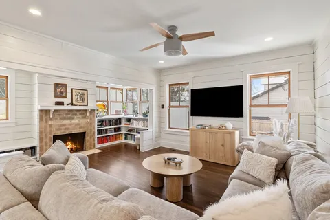 a living room with furniture flat screen tv and a fireplace