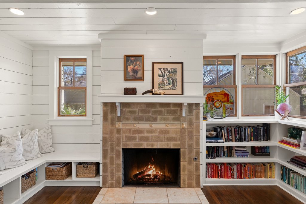 3107 Beverly Road Austin, TX 78703 - Photo 7 of 40 a living room with a fireplace and a book shelf