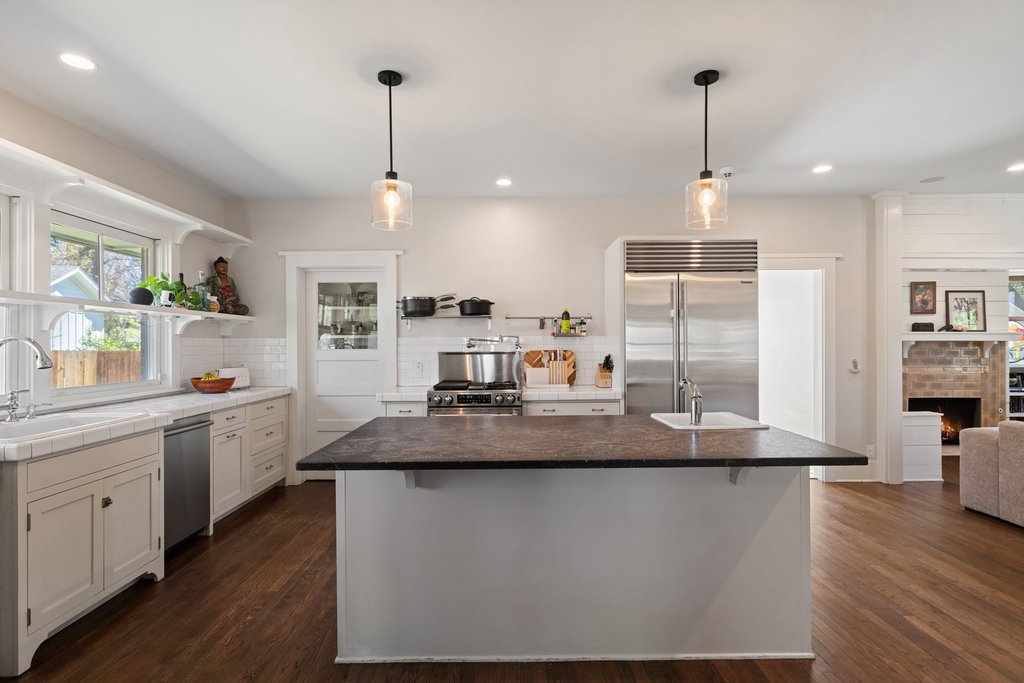 3107 Beverly Road Austin, TX 78703 - Photo 10 of 40 a kitchen with kitchen island granite countertop a sink a counter space and wooden floor