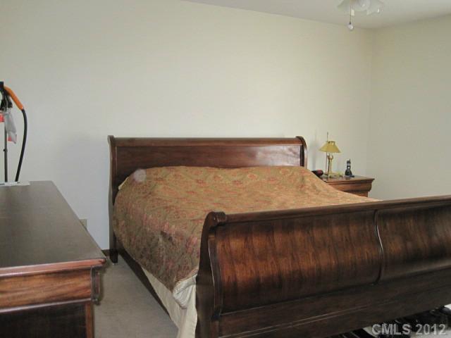 3325 Williamson Road Rock Hill, SC 29730 - Photo 14 of 16 a bed sitting in a bedroom next to a cabinet