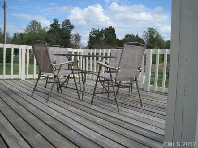 3325 Williamson Road Rock Hill, SC 29730 - Photo 10 of 16 a view of a roof deck with table and chairs with wooden floor and fence