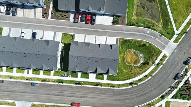 1221 West 1870 South Logan, UT 84321 - Photo 17 of 20 Aerial perspective showcasing a community with multiple residential buildings featuring dark gray shingle roofs