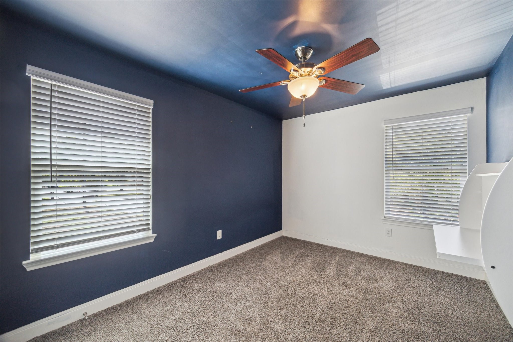 6047 Floyd Street Houston, TX 77007 - Photo 13 of 22 a view of an empty room with a ceiling fan and a window