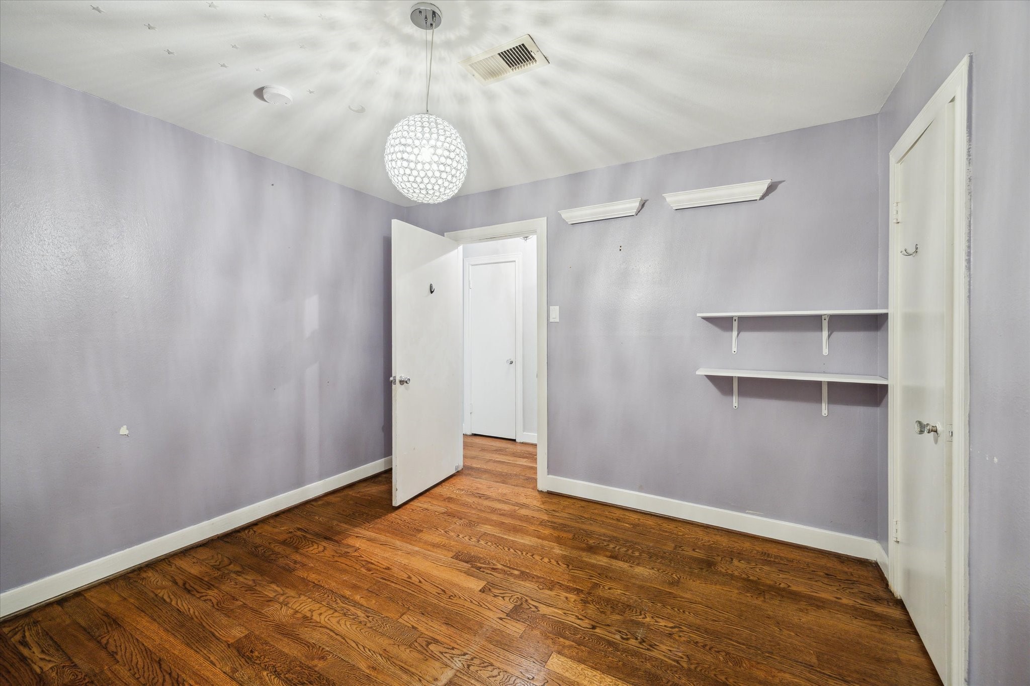 6047 Floyd Street Houston, TX 77007 - Photo 15 of 22 a view of an empty room with a chandelier fan