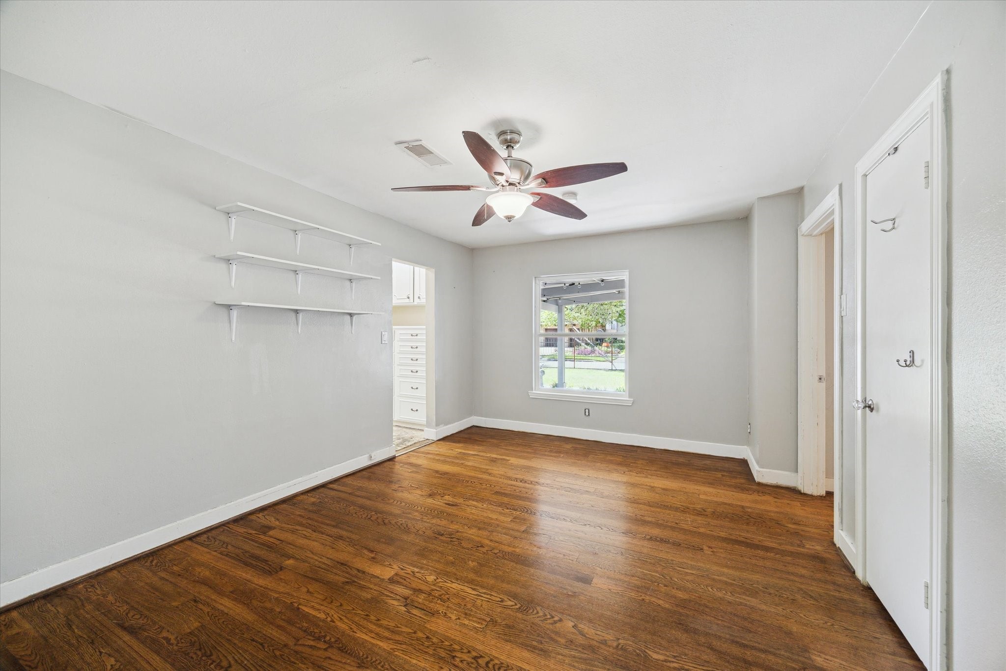 6047 Floyd Street Houston, TX 77007 - Photo 16 of 22 a view of an empty room with window and wooden floor