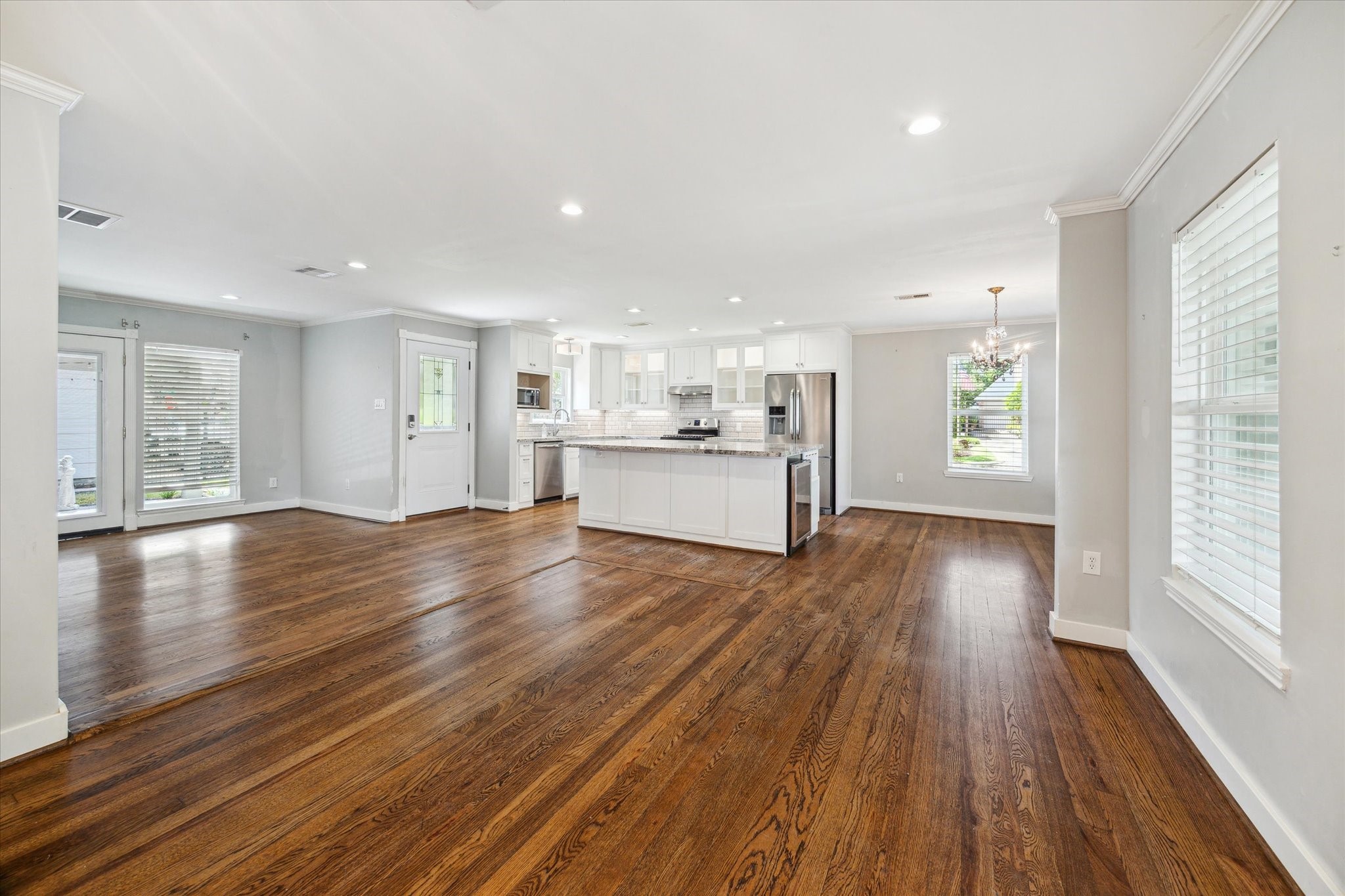6047 Floyd Street Houston, TX 77007 - Photo 4 of 22 a view of a big room with wooden floor and windows