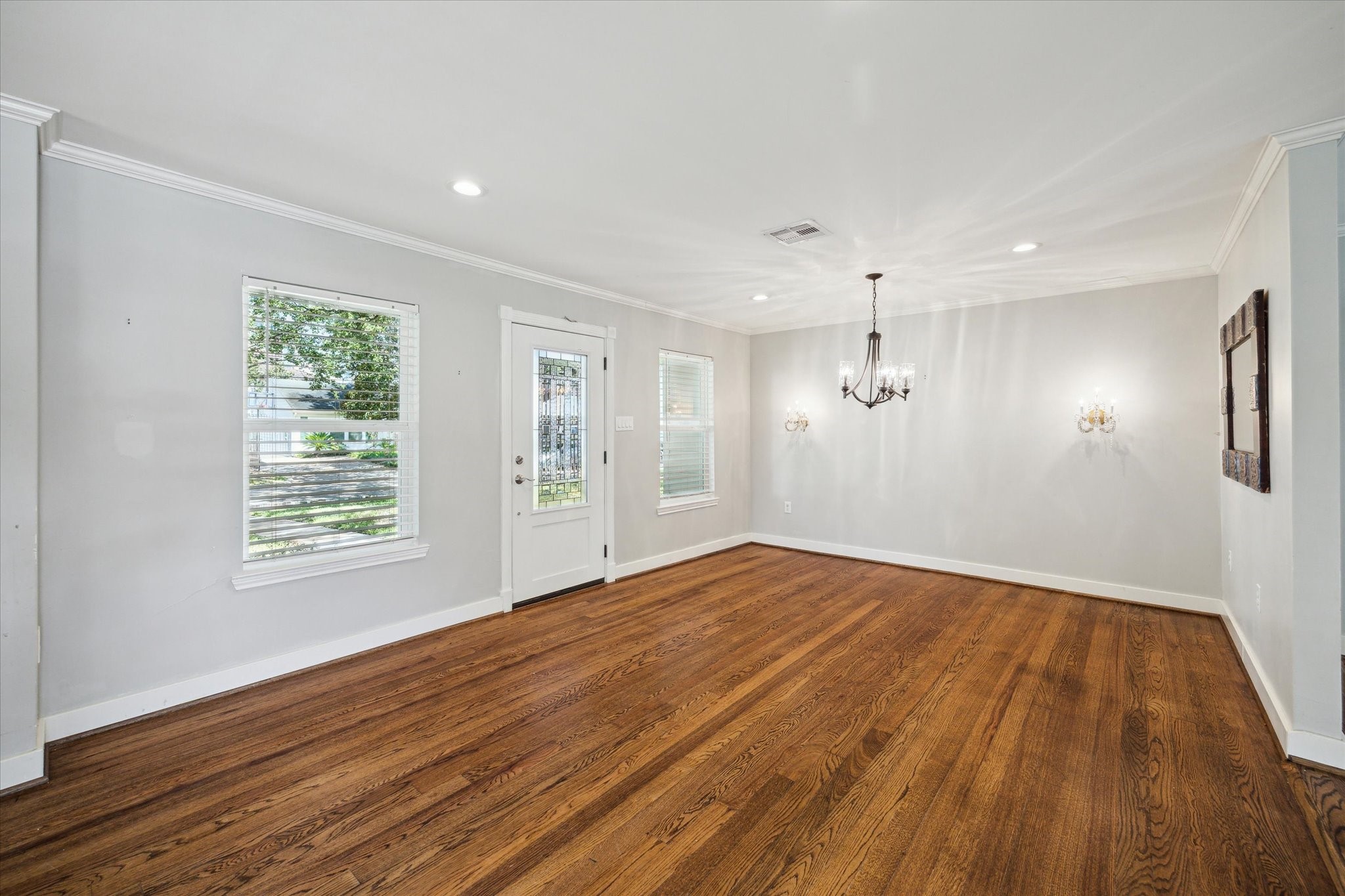 6047 Floyd Street Houston, TX 77007 - Photo 5 of 22 a view of an empty room with wooden floor and a window