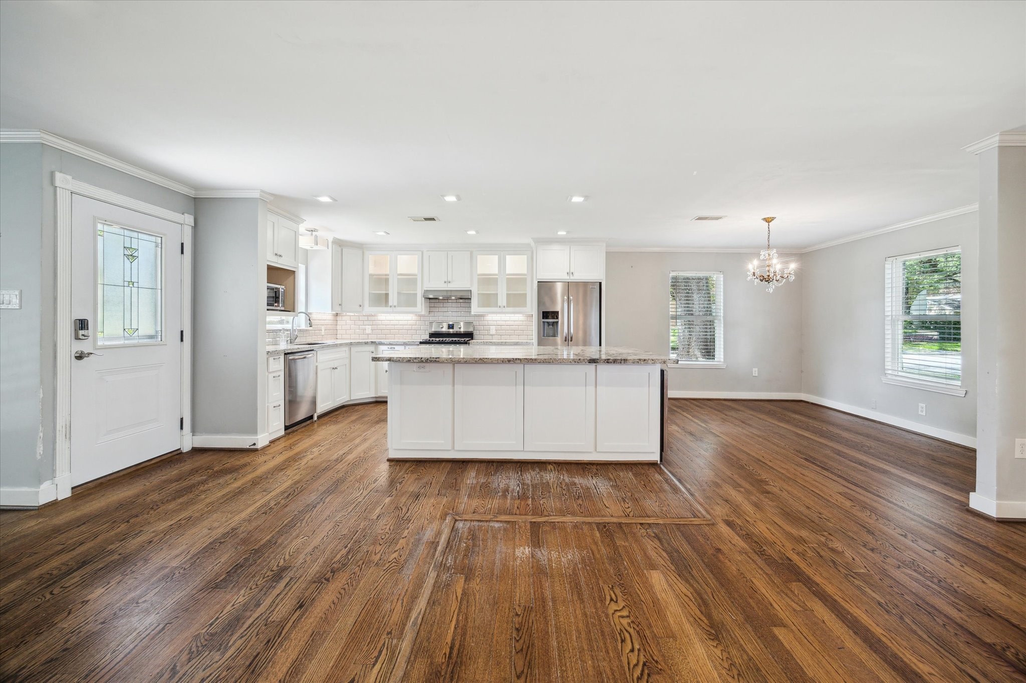 6047 Floyd Street Houston, TX 77007 - Photo 8 of 22 a large kitchen with wooden floors and stainless steel appliances