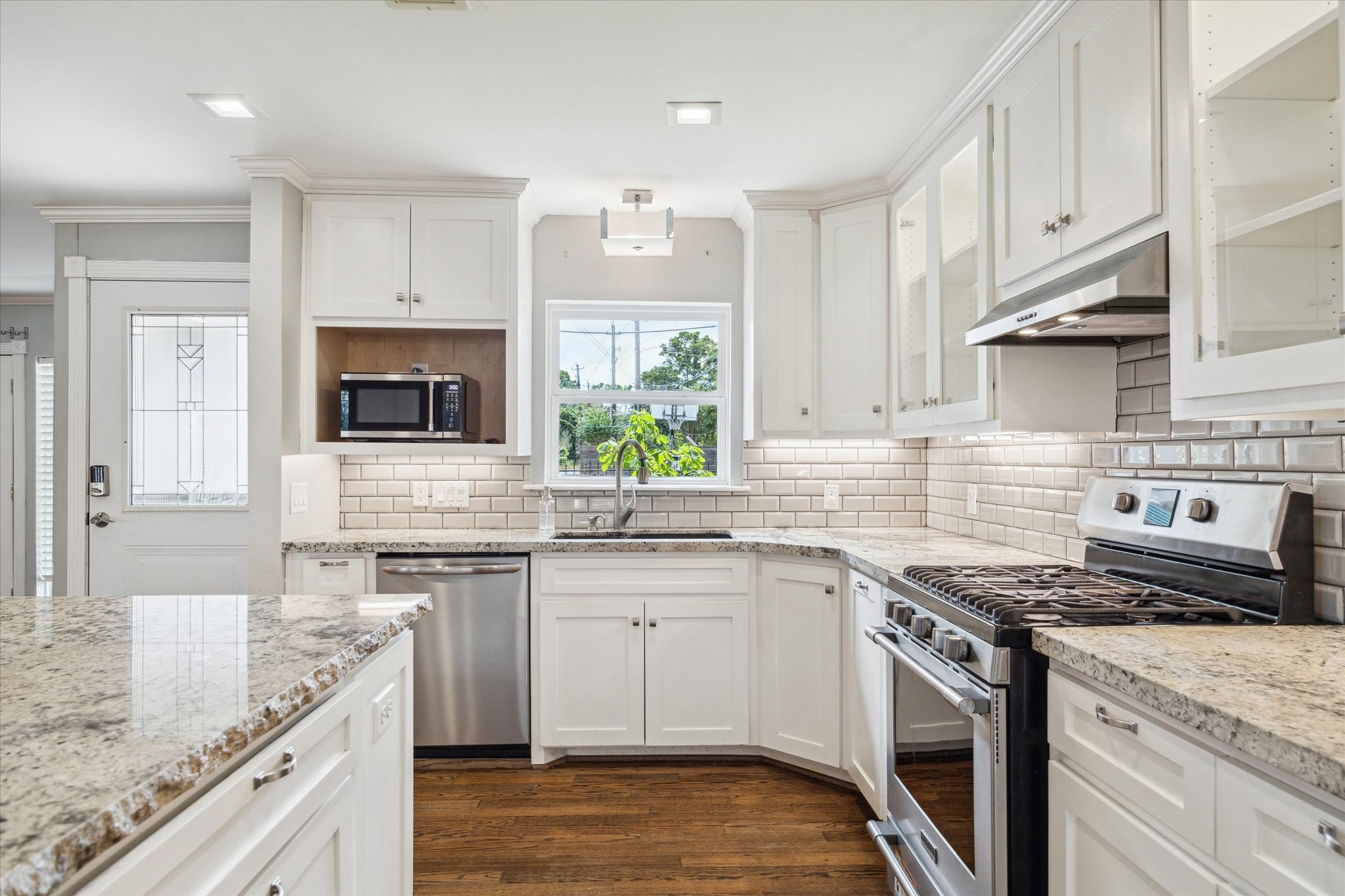 6047 Floyd Street Houston, TX 77007 - Photo 9 of 22 a kitchen with stainless steel appliances granite countertop a sink stove and cabinets