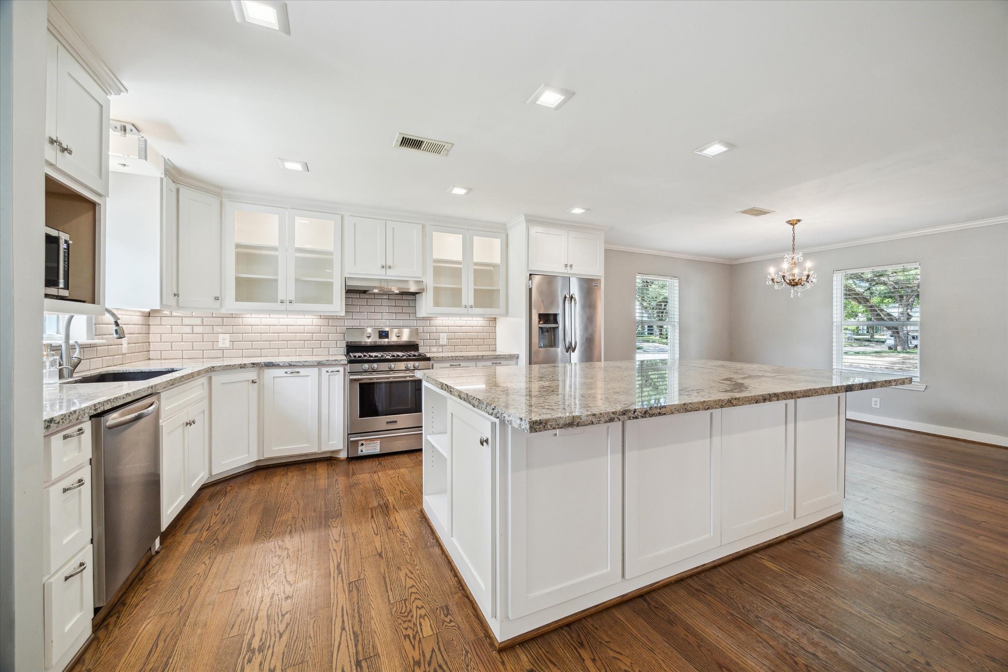 6047 Floyd Street Houston, TX 77007 - Photo 10 of 22 a kitchen with granite countertop a sink cabinets and wooden floor