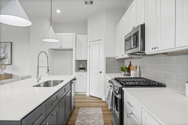 a view of kitchen with cabinets table and chairs