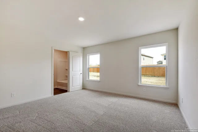 an empty room with windows and closet