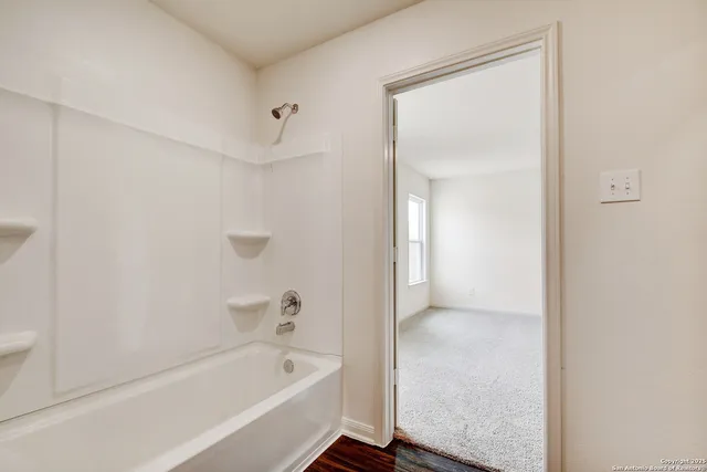 a bathroom with a bathtub and a shower