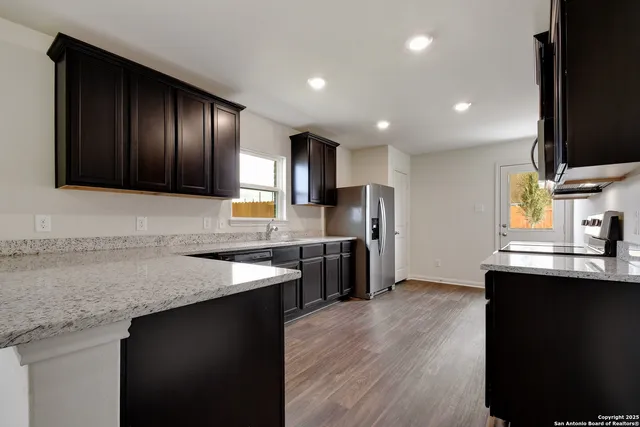 a kitchen with refrigerator and cabinets