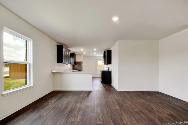 a view of kitchen with wooden floor and electronic appliances