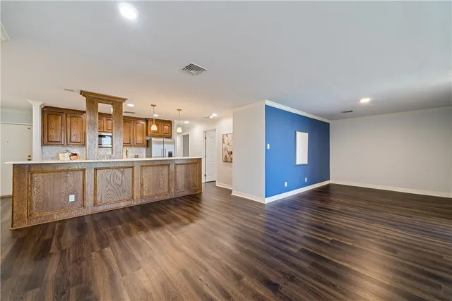 a kitchen with counter top space and wooden floor