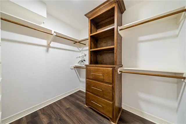 a bathroom with a granite countertop sink a toilet a mirror and shower