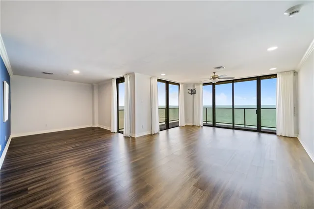 a view of a room with wooden floor and windows