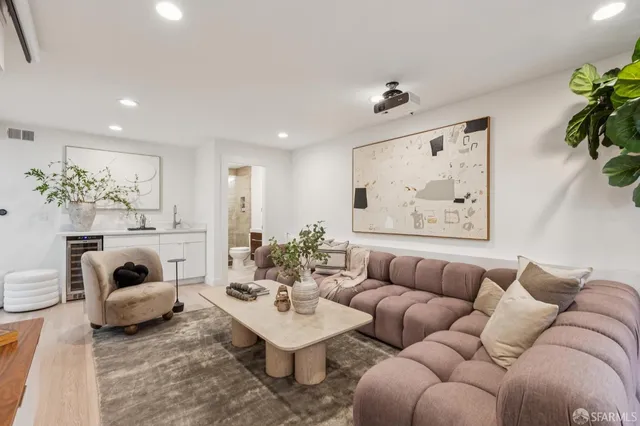 a living room with furniture and a chandelier
