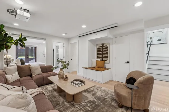 a living room with furniture and wooden floor