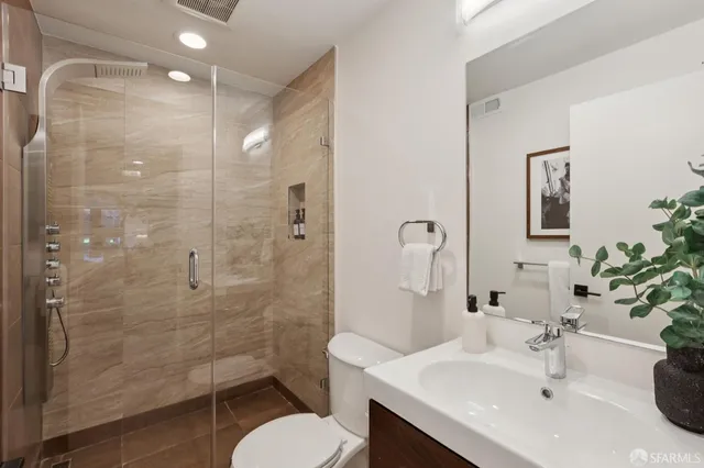 a bathroom with a sink toilet and shower