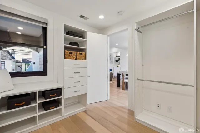 a hallway with cabinet and wooden floor
