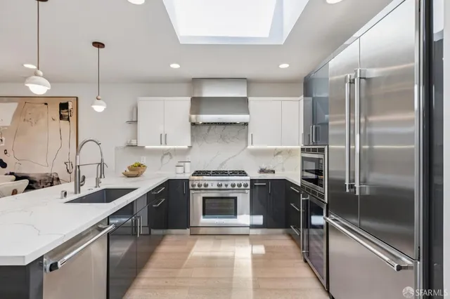 a kitchen with a sink stainless steel appliances and cabinets