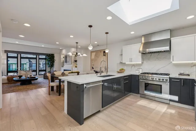 a kitchen with lots of counter top space and stainless steel appliances