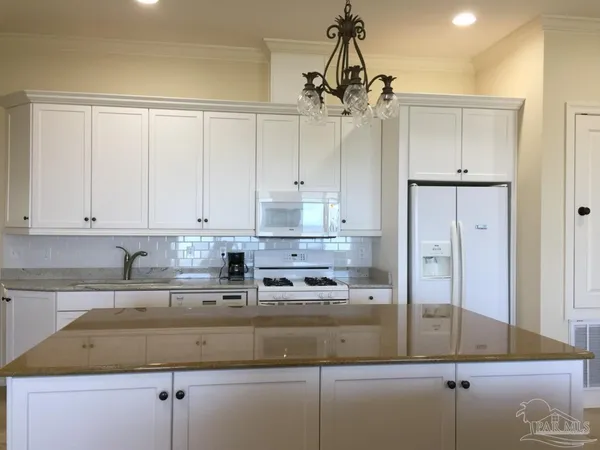 a living room with furniture and kitchen view