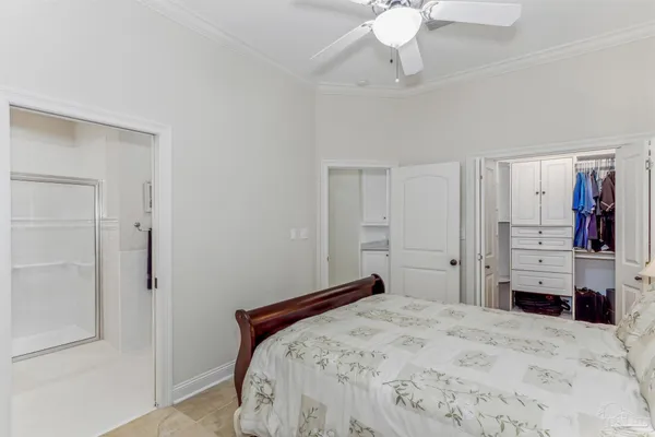 a kitchen with granite countertop a stove a sink and white cabinets with wooden floor