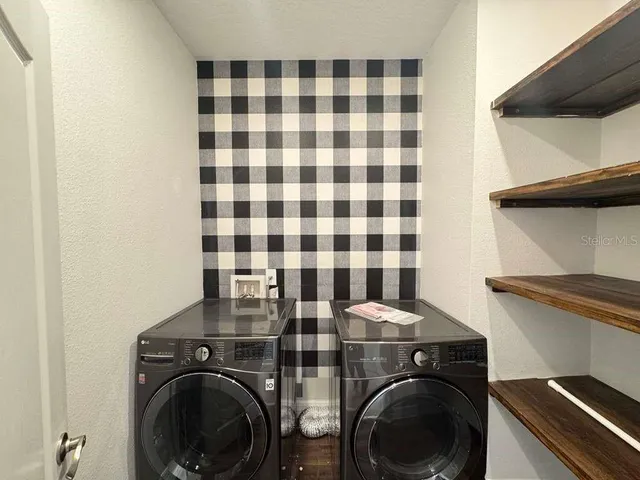 a view of a room with a ceiling fan and a window
