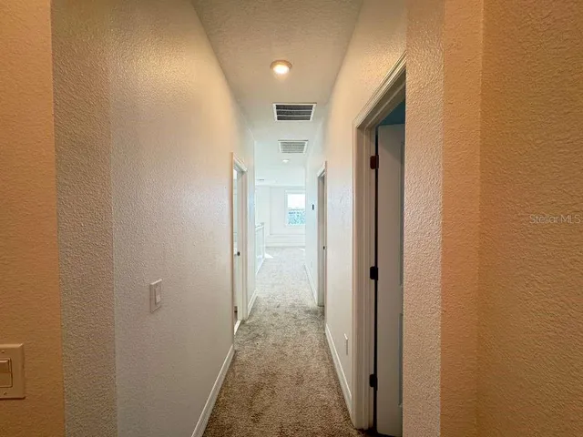 a view of a room with a chandelier fan