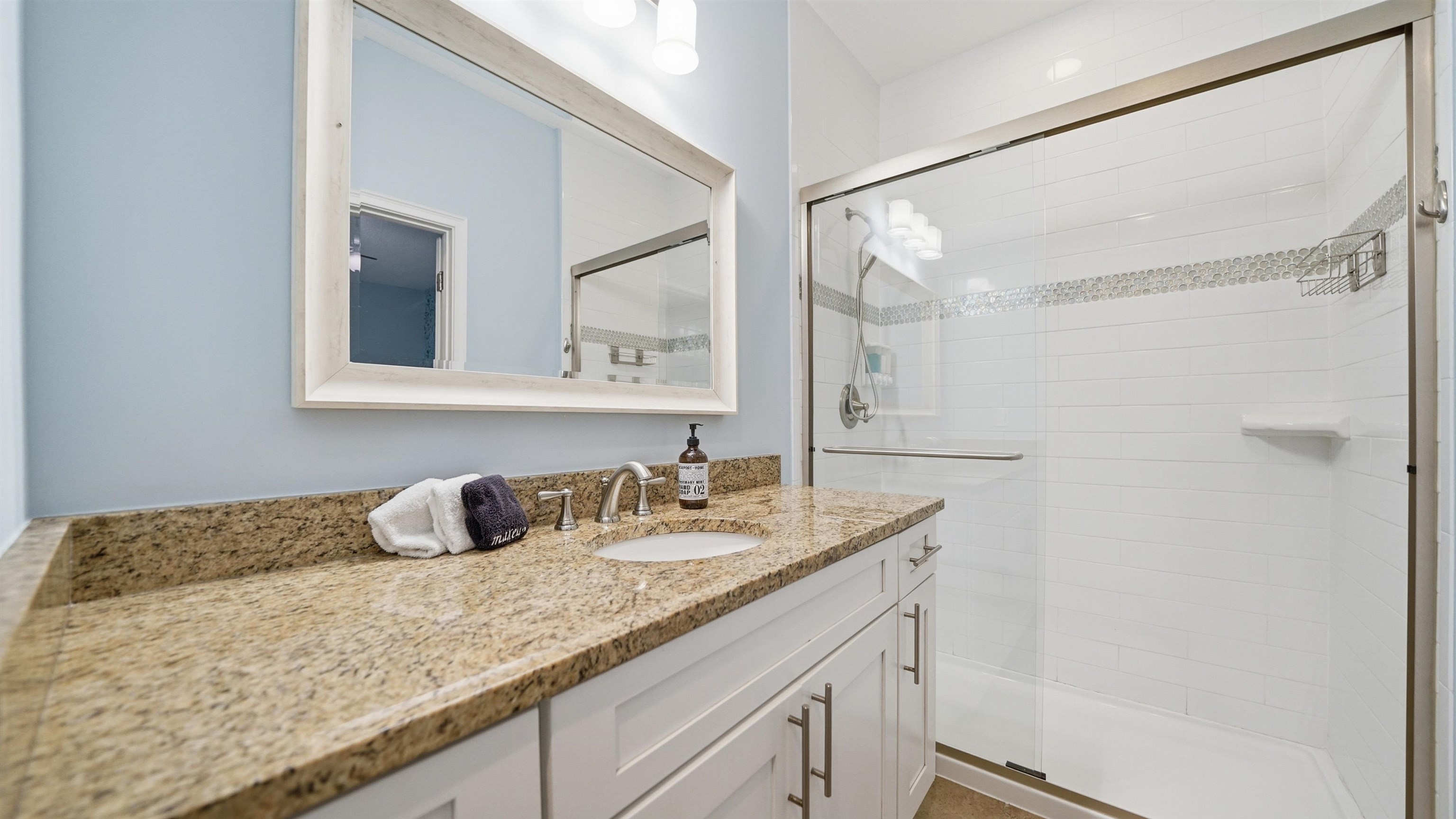 251 Riberia Street St. Augustine, FL 32084 - Photo 19 of 94 a bathroom with a granite countertop sink and a mirror