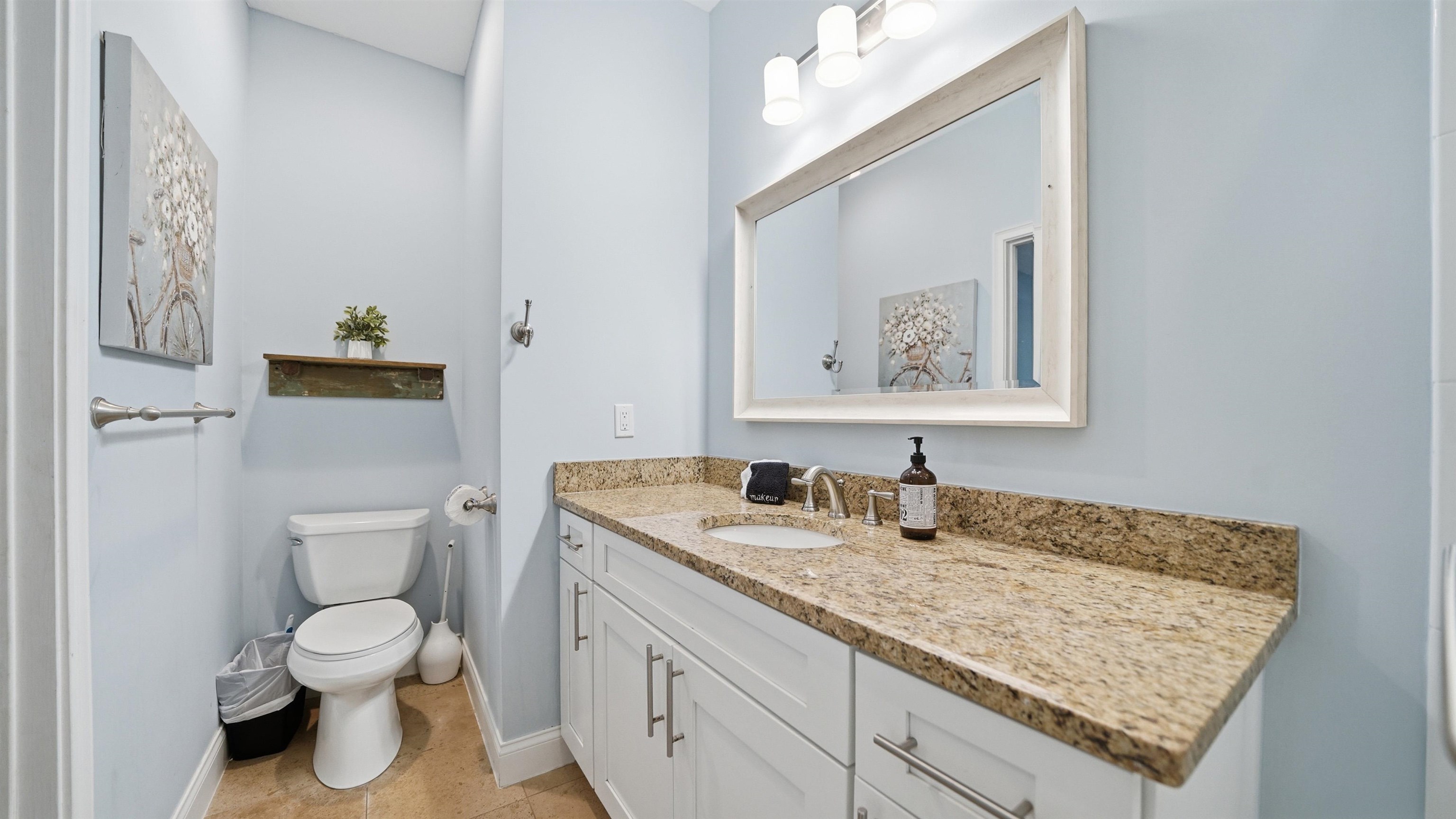 251 Riberia Street St. Augustine, FL 32084 - Photo 20 of 94 a bathroom with a granite countertop toilet sink and mirror