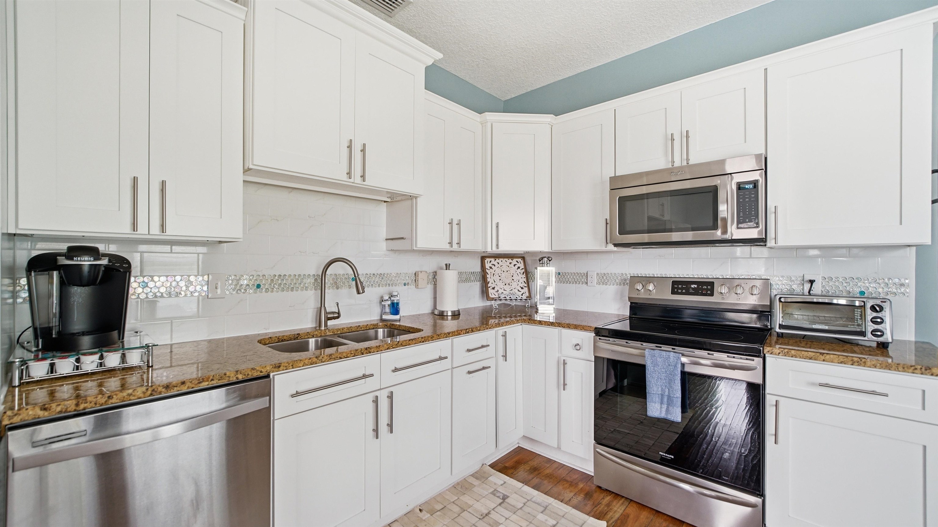 251 Riberia Street St. Augustine, FL 32084 - Photo 10 of 94 a kitchen with stainless steel appliances granite countertop a sink a stove a microwave and cabinets