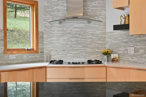 a bathroom with a granite countertop sink and a window